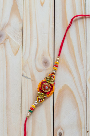 Raksha Bandhan background with an elegant Rakhi. A traditional Indian wrist band which is a symbol...