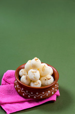 Indian Sweet - Rasgulla, Famous Bengali sweet in clay bowl with napkin