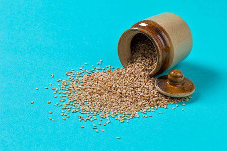 Sesame Seeds in pot on blue background