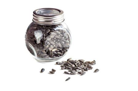 Sunflower Seeds in glass pot on white background. Helianthus annuus.の写真素材