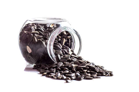 Sunflower Seeds in glass pot on white background. Helianthus annuus.の写真素材