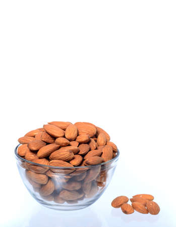 Almonds in a bowl isolated on a white backgroundの写真素材