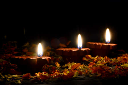 Clay diya lamps lit during diwali celebration. Greetings Card Design Indian Hindu Light Festival called Diwaliの写真素材