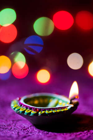 Clay diya lamps lit during Diwali Celebration. Greetings Card Design Indian Hindu Light Festival called Diwaliの写真素材