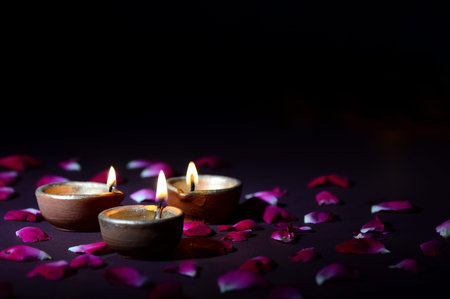 Clay diya lamps lit during diwali celebration. Greetings Card Design Indian Hindu Light Festival called Diwaliの写真素材