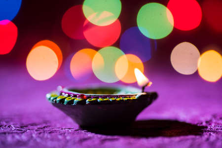 Clay diya lamps lit during Diwali Celebration. Greetings Card Design Indian Hindu Light Festival called Diwaliの写真素材
