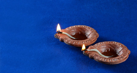 Clay diya lamps lit during diwali celebration. Greetings Card Design Indian Hindu Light Festival...