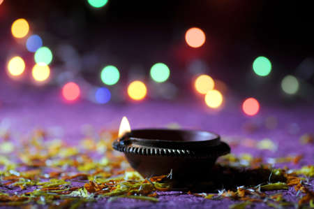 Clay diya lamps lit during Diwali Celebration. Greetings Card Design Indian Hindu Light Festival called Diwaliの写真素材