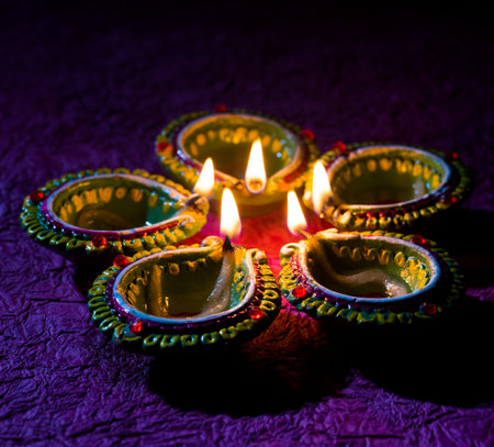 Clay diya lamps lit during Diwali Celebration. Greetings Card Design Indian Hindu Light Festival...