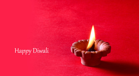 Clay diya lamps lit during diwali celebration. Greetings Card Design Indian Hindu Light Festival called Diwaliの写真素材