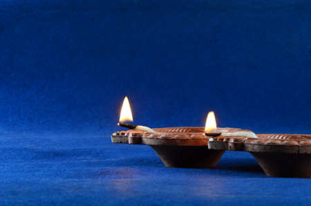 Clay diya lamps lit during diwali celebration. Greetings Card Design Indian Hindu Light Festival called Diwaliの写真素材