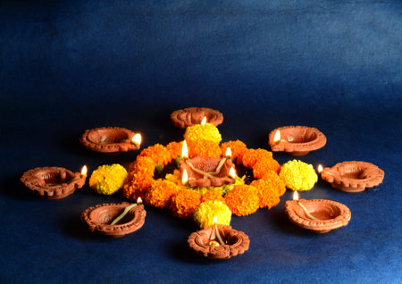 Clay diya lamps lit during diwali celebration. Greetings Card Design Indian Hindu Light Festival called Diwaliの写真素材