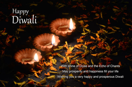 Clay diya lamps lit during Diwali Celebration. Greetings Card Design Indian Hindu Light Festival called Diwaliの写真素材