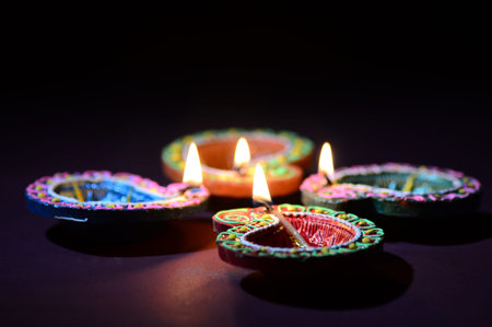 Colorful clay Diya (Lantern) lamps lit during Diwali celebration. Greetings Card Design Indian Hindu...