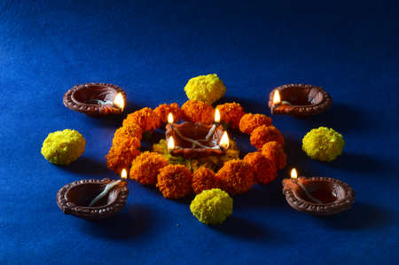 Clay diya lamps lit during diwali celebration. Greetings Card Design Indian Hindu Light Festival called Diwaliの写真素材
