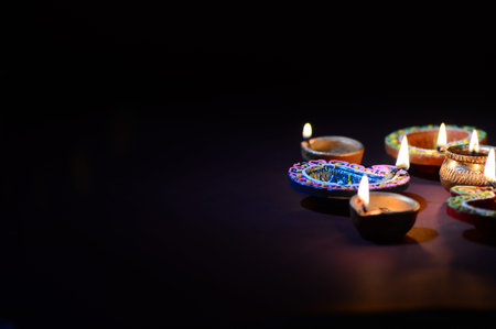 Colorful clay Diya (Lantern) lamps lit during Diwali celebration. Greetings Card Design Indian Hindu...