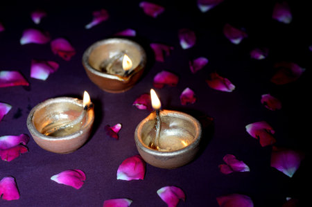 Traditional clay diya lamps lit during Diwali celebrationの写真素材