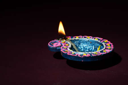 Colorful clay Diya (Lantern) lamps lit during Diwali celebration. Greetings Card Design Indian Hindu Light Festival called Diwali.の写真素材