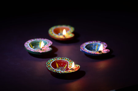 Colorful clay Diya (Lantern) lamps lit during Diwali celebration. Greetings Card Design Indian Hindu...