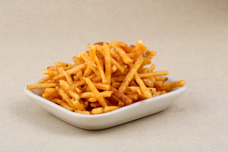 Deep fried salty dish - chivda or mixture made of gram flour and mixed with dry fruits.の写真素材