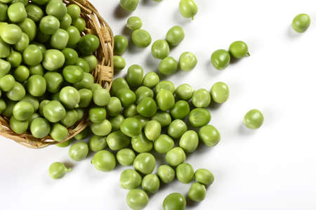 Fresh Green Peas in basket on white backgroundの写真素材