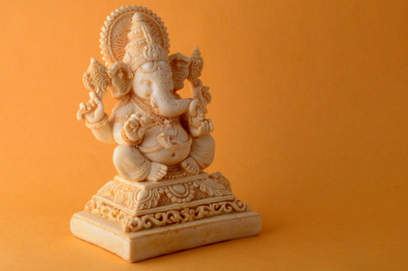Hindu God Ganesha. Ganesha Idol on yellow backgroundの写真素材