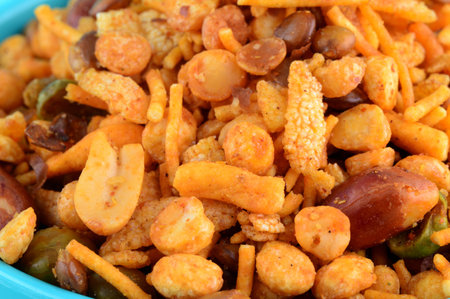 Indian Snacks : Mixture (roasted nuts with salt pepper masala, pulses, channa masala dal green peas) in blue bowl inの写真素材