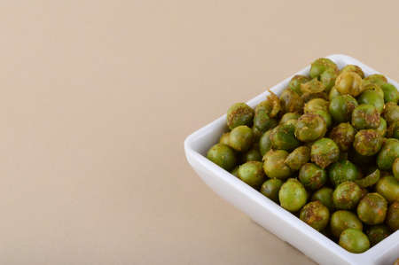 Indian snack: Mixture and Spiced fried green peas {chatpata matar} in white plate.の写真素材