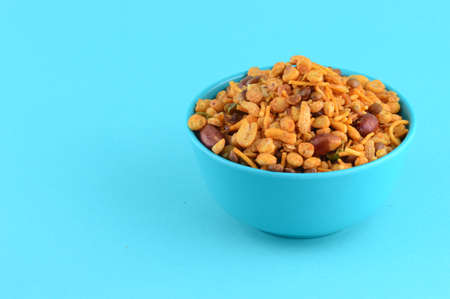 Indian Snacks : Mixture (roasted nuts with salt pepper masala, pulses, channa masala dal green peas) in blue bowl inの写真素材