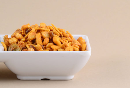 Indian Snacks : Mixture (roasted nuts with salt pepper masala, pulses, channa masala dal green peas) in blue bowl inの写真素材