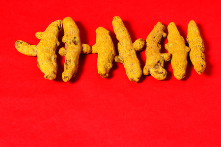 Barks of Yellow Turmeric on Red Backgroundの写真素材