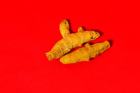 Barks of Yellow Turmeric on Red Background