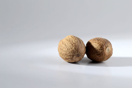Close up of Nutmeg on a gray background