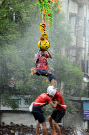 AMRAVATI, MAHARASHTRA, INDIA - AUGUST 29 : Crowd of young People enjoying "Govinda" at Dahi Handi festival to celebrate God Krishna's Birth in Amravati, Maharashtra, India. 29 August 2013のeditorial素材