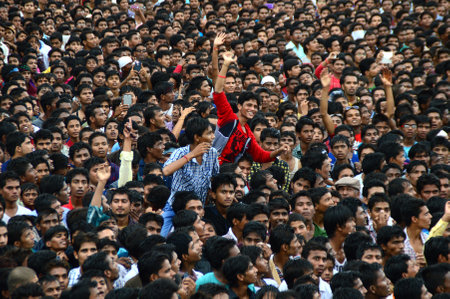 AMRAVATI, MAHARASHTRA, INDIA - AUGUST 24 : Crowd of young People enjoying "Govinda" at Dahi Handi festival to celebrate God Krishna's Birth in Amravati, Maharashtra, India. 24 August 2014のeditorial素材