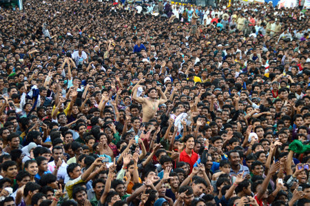 AMRAVATI, MAHARASHTRA, INDIA - AUGUST 24 : Crowd of young People enjoying "Govinda" at Dahi Handi festival to celebrate God Krishna's Birth in Amravati, Maharashtra, India. 24 August 2014のeditorial素材