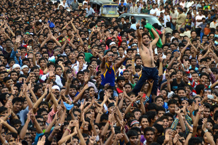 AMRAVATI, MAHARASHTRA, INDIA - AUGUST 24 : Crowd of young People enjoying "Govinda" at Dahi Handi festival to celebrate God Krishna's Birth in Amravati, Maharashtra, India. 24 August 2014のeditorial素材