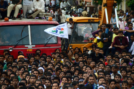 AMRAVATI, MAHARASHTRA, INDIA - AUGUST 24 : Crowd of young People enjoying "Govinda" at Dahi Handi festival to celebrate God Krishna's Birth in Amravati, Maharashtra, India. 24 August 2014のeditorial素材