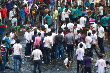AMRAVATI, MAHARASHTRA, INDIA - AUGUST 24 : Crowd of young People enjoying "Govinda" at Dahi Handi festival to celebrate God Krishna's Birth in Amravati, Maharashtra, India. 24 August 2014のeditorial素材