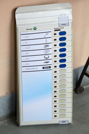 NAGPUR, INDIA - 15 OCT 2014: unidentified people and polling officers looks for a voters name in the...