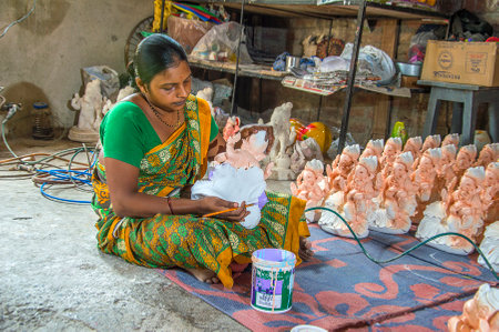 AMRAVATI, MAHARASHTRA - 26 AUGUST 2016 : Artist gives finishing touches on an idol of the Hindu god Lord Ganesha at an artist's workshop for Ganesha-festival, 26 August 2016, Maharashtra, India.のeditorial素材