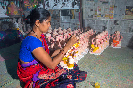AMRAVATI, MAHARASHTRA - 26 AUGUST 2016 : Artist gives finishing touches on an idol of the Hindu god Lord Ganesha at an artist's workshop for Ganesha-festival, 26 August 2016, Maharashtra, India.のeditorial素材