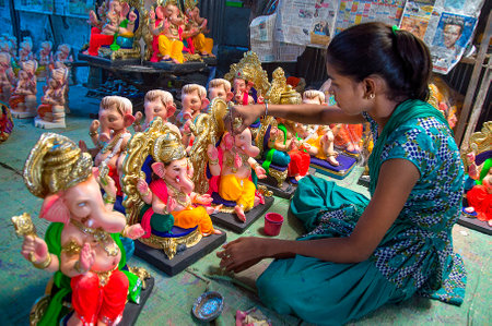AMRAVATI, MAHARASHTRA - 26 AUGUST 2016 : Artist gives finishing touches on an idol of the Hindu god Lord Ganesha at an artist's workshop for Ganesha-festival, 26 August 2016, Maharashtra, India.のeditorial素材