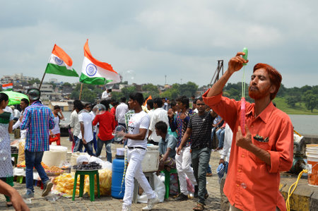 NAGPUR, MAHARASHTRA, INDIA, AUGUST - 15 : Unidentified people celebrating Independence Day by dancing and waving Indian flag (tri-colour) at futala lake in Nagpur on 15 August 2015のeditorial素材