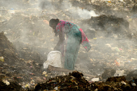 AMRAVATI, MAHARASHTRA, INDIA - APRIL 09, 2014: Unidentified rag pickers search for recyclable...