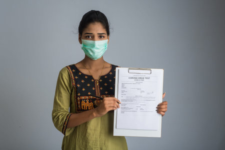 Coronavirus concept for a blood test. A young girl reading or filling a medical test form for...