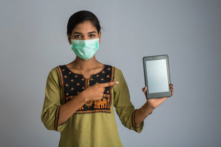 woman hand showing smart mobile phone with safety medical face mask, Health care and infection...