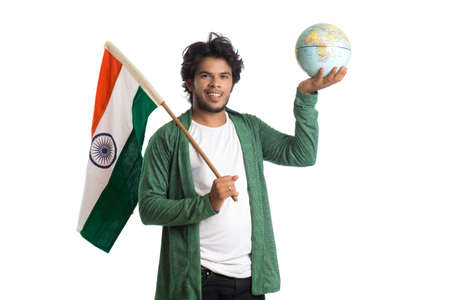Young man with Indian flag or tricolor with world globe on white background, Indian Independence day, Indian Republic dayの写真素材