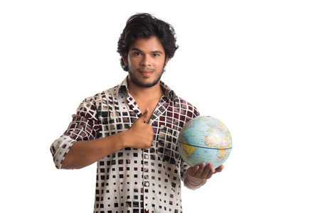 young man with a world globe on a white background.