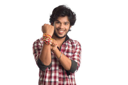 Young men showing rakhi on his hand on an occasion of Raksha Bandhan festival.の写真素材